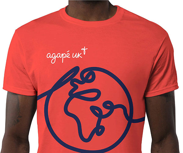  guy wearing an Agape t-shirt featuring a stylised globe drawn with the charity's unbreakable line