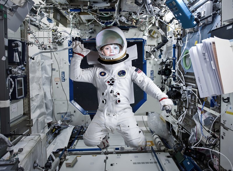 Teach First "Challenge the Impossible" campaign visuals showing a young girl dressed in a space suit, floating on the International Space Station