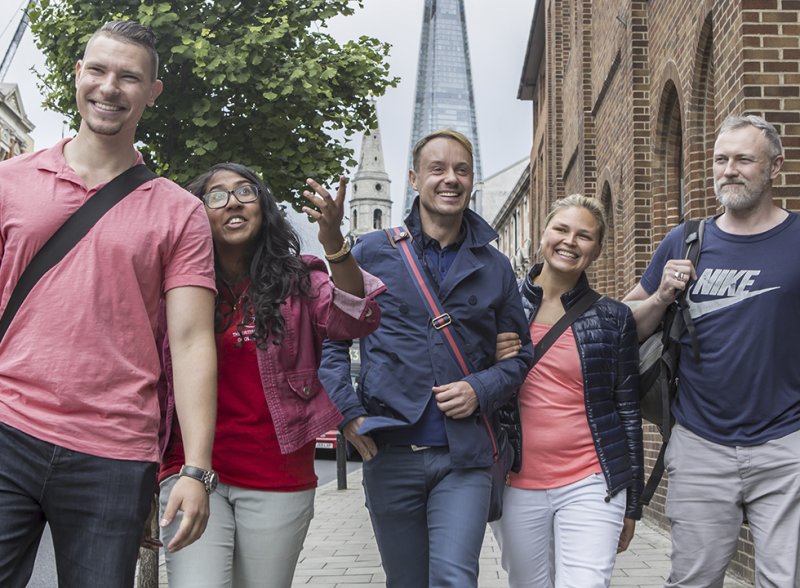 Osteopathy students walking along the street in London, with The Shard building visible behind them