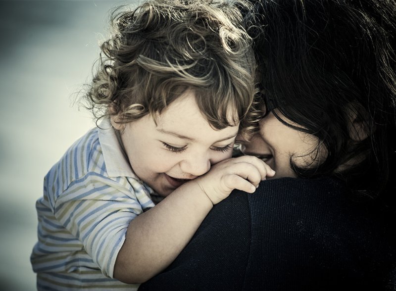 WDP brand image of a small child hugging its mum, both smiling