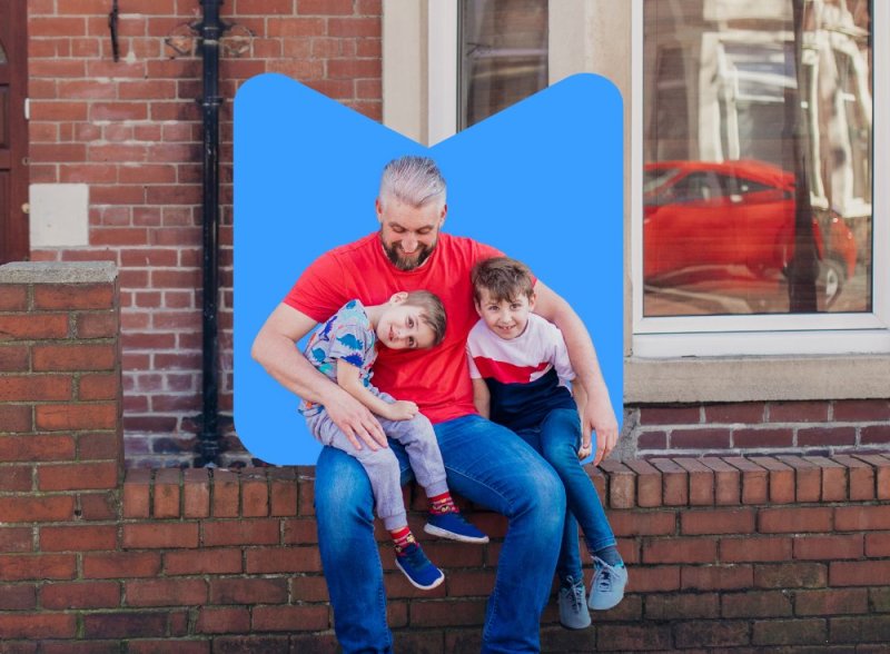 Family Action hero image of a man and his sons having fun, sat on a wall