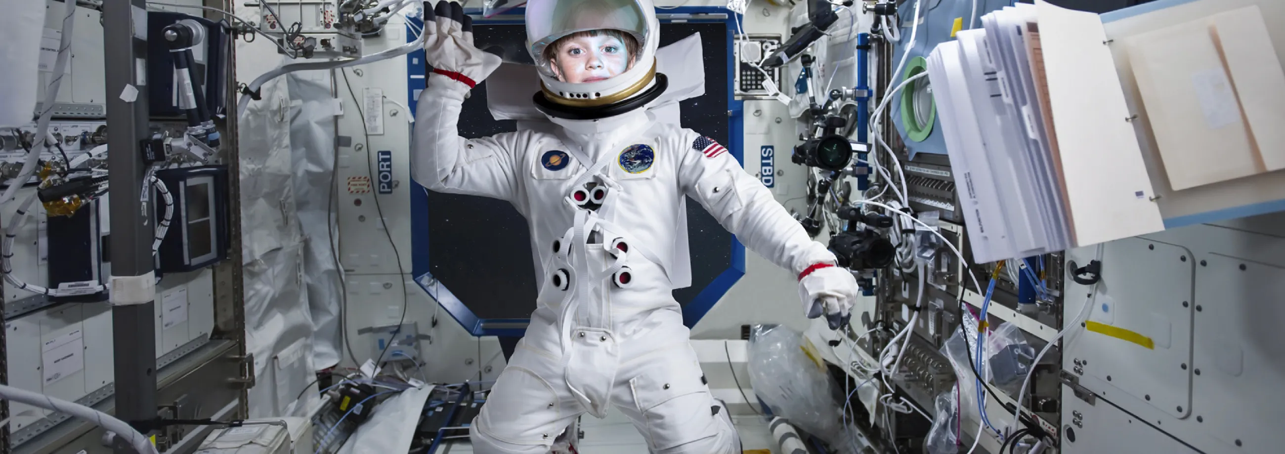 Teach First "Challenge the Impossible" campaign visuals showing a young girl dressed in a space suit, floating on the International Space Station