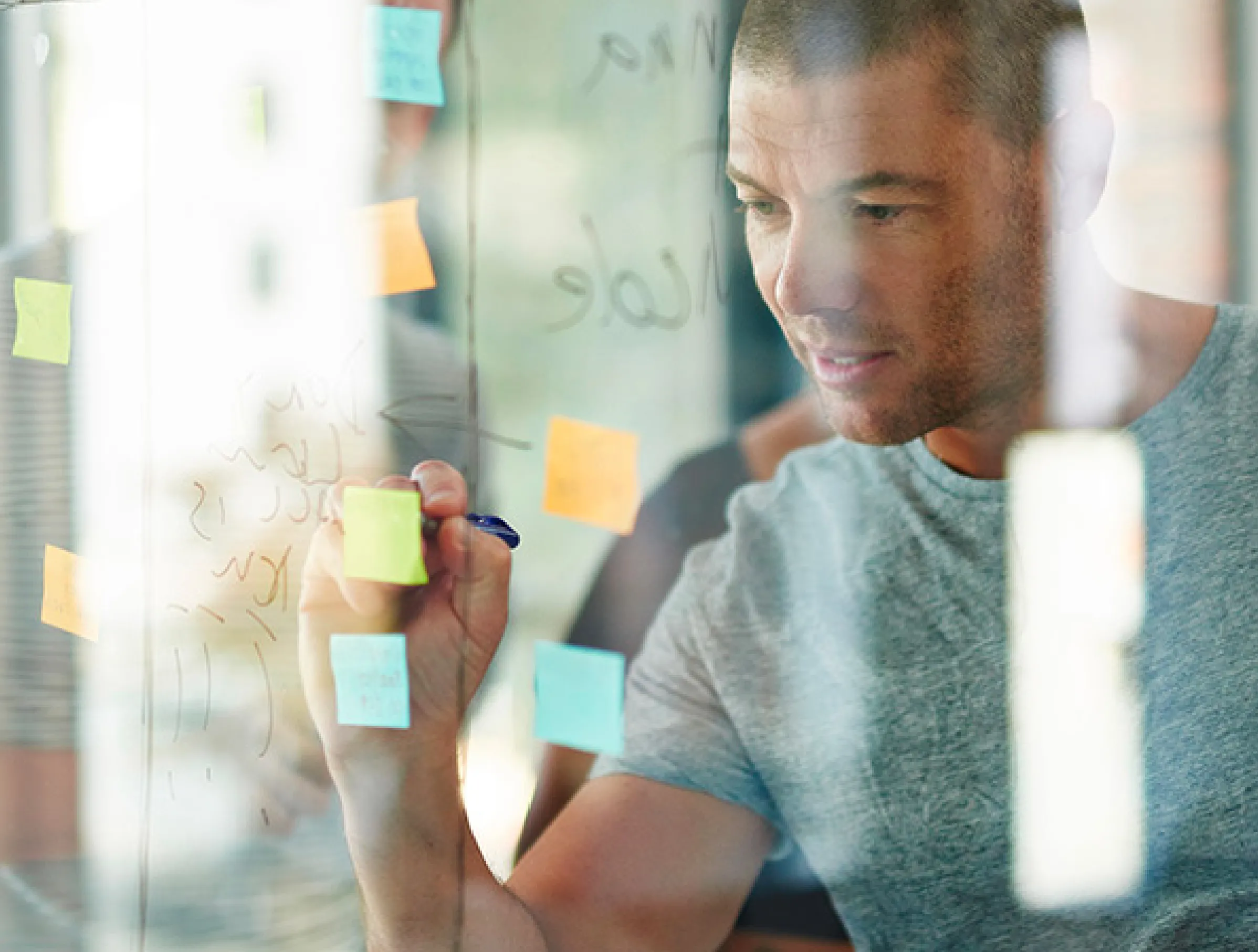 Career Ready brand consultancy image showing a man writing on post it notes